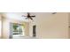 A beige bedroom with a ceiling fan and sliding doors leading to a screened porch at 3205 Sonesta Ct # F, Clermont, FL 34711