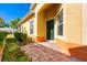 Inviting front entrance with a dark green door, beautiful brick walkway, and well-maintained landscaping at 3205 Sonesta Ct # F, Clermont, FL 34711