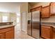 Kitchen view featuring stainless steel refrigerator, granite countertops and wood cabinets at 3205 Sonesta Ct # F, Clermont, FL 34711