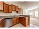 Updated kitchen with stainless steel dishwasher, tile floors, and bar seating at 3205 Sonesta Ct # F, Clermont, FL 34711