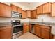 Well-equipped kitchen with stainless steel appliances and light wood cabinetry at 3205 Sonesta Ct # F, Clermont, FL 34711