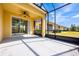 The lanai features screens, a concrete floor, and a sliding glass door entry into the house at 3205 Sonesta Ct # F, Clermont, FL 34711