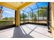Covered lanai featuring screens, a concrete floor, and views of the backyard at 3205 Sonesta Ct # F, Clermont, FL 34711