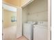 This laundry room includes a washer, dryer, and built-in shelving for convenient storage at 3205 Sonesta Ct # F, Clermont, FL 34711
