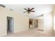 A spacious living room with carpet flooring and a ceiling fan at 3205 Sonesta Ct # F, Clermont, FL 34711