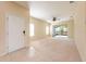 Open concept living area with a view of the lanai, neutral carpet, and a ceiling fan at 3205 Sonesta Ct # F, Clermont, FL 34711