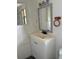 A bathroom features a mirror, sink, and towel holder at 3772 Cochran St, Apopka, FL 32703
