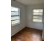 Bedroom with hardwood floors and two window views at 3772 Cochran St, Apopka, FL 32703