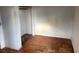 A bedroom with bare walls and wooden floors with closet at 3772 Cochran St, Apopka, FL 32703