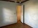 View of a bedroom with hardwood flooring and an open door at 3772 Cochran St, Apopka, FL 32703