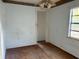 Empty bedroom with wood floors, light blue walls, and a window overlooking the yard at 3772 Cochran St, Apopka, FL 32703