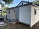 Rear exterior view of a house with a weathered back door, set in a grassy yard at 3772 Cochran St, Apopka, FL 32703