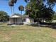 Modest single-story house with a chain-link fence and mature trees on a sunny day at 3772 Cochran St, Apopka, FL 32703