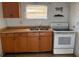 Kitchen with wooden cabinets, sink, and white oven at 3772 Cochran St, Apopka, FL 32703