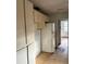 Angle of kitchen with cabinets and a full-sized refrigerator at 3772 Cochran St, Apopka, FL 32703