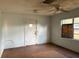 Empty living room with white walls, worn floors, a ceiling fan, and a window at 3772 Cochran St, Apopka, FL 32703