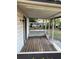Enclosed front porch with a wood floor and a view of the yard and surrounding neighborhood at 3772 Cochran St, Apopka, FL 32703