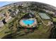 Aerial view showcasing the community pool, clubhouse, tennis court, and beautifully landscaped grounds in a serene setting at 427 Egret Place Dr, Winter Garden, FL 34787