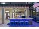 Outdoor bar features a tiled countertop, blue accent lighting, a grill, a sink, and shelving in a covered backyard area at 427 Egret Place Dr, Winter Garden, FL 34787