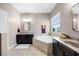 This bathroom includes a soaking tub, dual vanities, and a window providing natural light at 427 Egret Place Dr, Winter Garden, FL 34787