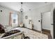 Bright bedroom with a daybed, stylish rug, and decorative chandelier at 427 Egret Place Dr, Winter Garden, FL 34787