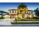 Stunning two-story home with a three-car garage, mature landscaping, and inviting curb appeal at twilight at 427 Egret Place Dr, Winter Garden, FL 34787
