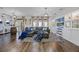 Comfortable living room with dark wood floors, large sectional sofa, and stylish decor at 427 Egret Place Dr, Winter Garden, FL 34787