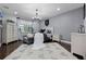 This bedroom features a chandelier, dark hardwood floors, a light gray paint scheme, and a patterned Mickey Mouse rug at 427 Egret Place Dr, Winter Garden, FL 34787