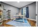 This home office space features a large window, built-in display cases, and hardwood floors at 427 Egret Place Dr, Winter Garden, FL 34787