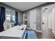 This is a well-lit home office with hardwood floors and blue curtains by the window at 427 Egret Place Dr, Winter Garden, FL 34787