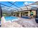 Spacious outdoor pool area featuring a screened-in pool, outdoor bar, and covered patio at 427 Egret Place Dr, Winter Garden, FL 34787