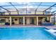 Backyard features a pool and covered lanai, complete with an outdoor kitchen, bar, and lounge area for outdoor relaxation at 427 Egret Place Dr, Winter Garden, FL 34787