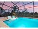 Sparkling pool features stylish lounge chairs submerged in the water and a serene view with a screened-in enclosure at 427 Egret Place Dr, Winter Garden, FL 34787