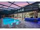 Inviting pool with a bar and lounge chairs offers a perfect blend of relaxation and entertainment in the backyard oasis at 427 Egret Place Dr, Winter Garden, FL 34787