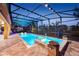 Enclosed pool and spa featuring a brick surround, colorful lighting, and black metal enclosure at 427 Egret Place Dr, Winter Garden, FL 34787
