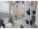 Bathroom featuring a shower/tub combination with tiled walls, accented by a fun shower curtain at 427 Egret Place Dr, Winter Garden, FL 34787
