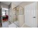 This bathroom features a sleek glass shower with neutral tile and a convenient door to the bedroom at 427 Egret Place Dr, Winter Garden, FL 34787