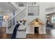 Elegant staircase with wrought iron railings and charming dog house feature, adding character to the home at 427 Egret Place Dr, Winter Garden, FL 34787
