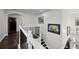 Upstairs hallway showcasing iron railing and access to the home theater at 427 Egret Place Dr, Winter Garden, FL 34787