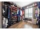This walk-in closet features custom shelving for shoes and clothing, as well as a window for natural light at 427 Egret Place Dr, Winter Garden, FL 34787