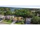Overhead view of a house with a well-kept lawn and palm trees, with a lake visible in the distance at 453 Kettering Rd, Deltona, FL 32725