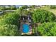 Overhead of the community pool and amenities with lush landscaping around the property at 453 Kettering Rd, Deltona, FL 32725