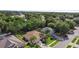 Aerial view of a well-maintained home with a two-car garage, lush lawn, and mature trees at 453 Kettering Rd, Deltona, FL 32725
