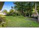 Lush backyard featuring mature trees, green grass, and shade; perfect for outdoor enjoyment at 453 Kettering Rd, Deltona, FL 32725