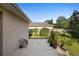 Backyard patio featuring lush greenery and well-maintained lawn, creating an inviting outdoor oasis at 453 Kettering Rd, Deltona, FL 32725