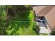Aerial view of a well-maintained backyard featuring lush landscaping, green grass, stepping stones, and a patio at 453 Kettering Rd, Deltona, FL 32725