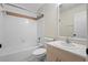 Bright bathroom featuring a tub with shower, tile surround, and vanity with sink at 453 Kettering Rd, Deltona, FL 32725