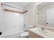 Clean bathroom with white tiled walls, a shower-tub combination, and a vanity sink at 453 Kettering Rd, Deltona, FL 32725