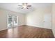 Comfortable bedroom with new hardwood floors and a door that leads to a patio at 453 Kettering Rd, Deltona, FL 32725