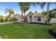 Desirable home showcasing mature landscaping, a green lawn, and a welcoming facade at 453 Kettering Rd, Deltona, FL 32725